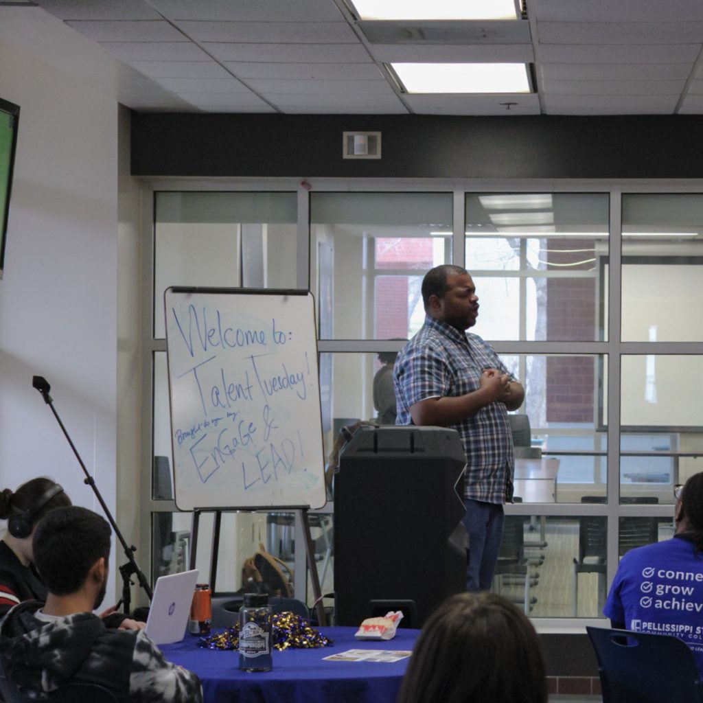 A student performs as a crowd watches.
