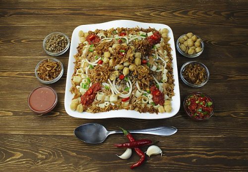 A dish of traditional Egyptian food surrounded by spices