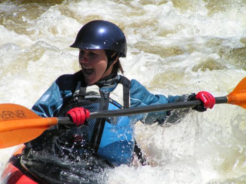 Person kayaking down a river