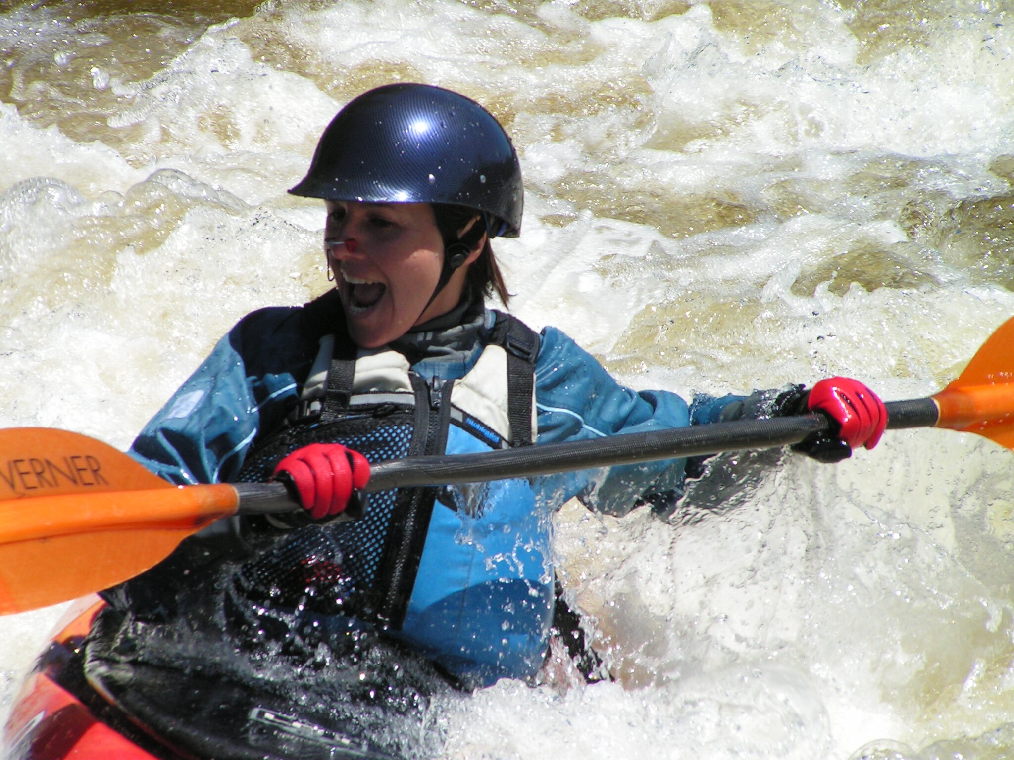 Person kayaking down a river