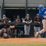 Man hits a baseball during a game.