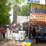 Restaurant vendor signs line street.