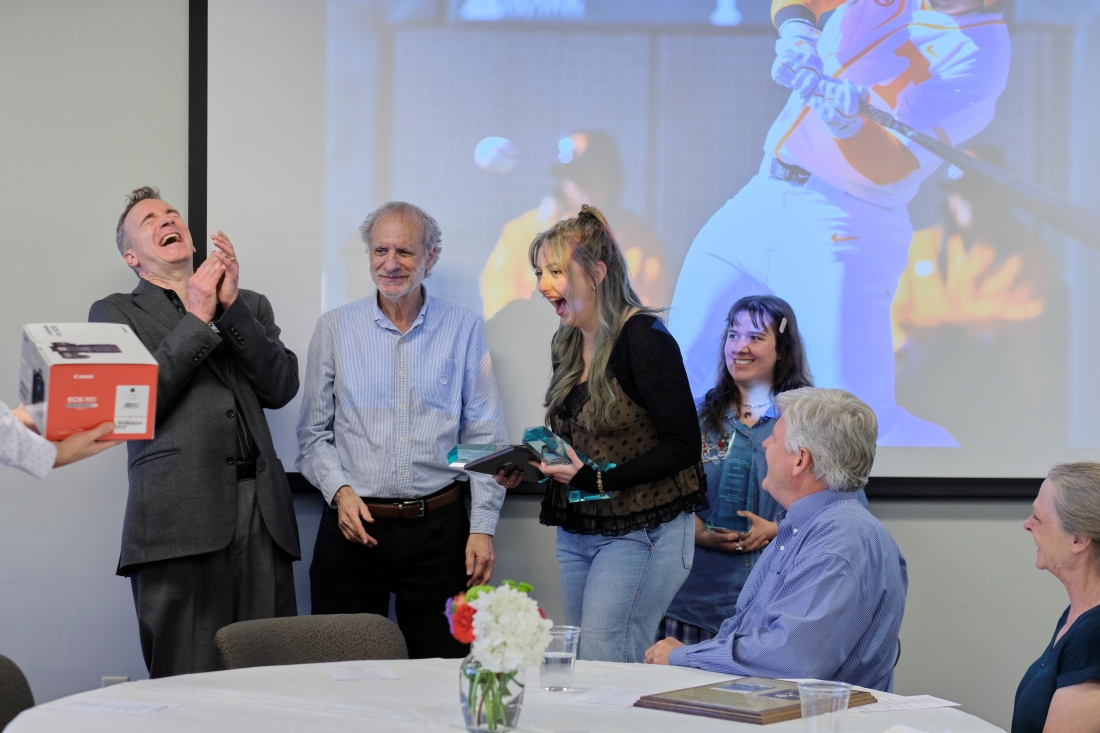 Man laughs as woman excitedly receives a camera.