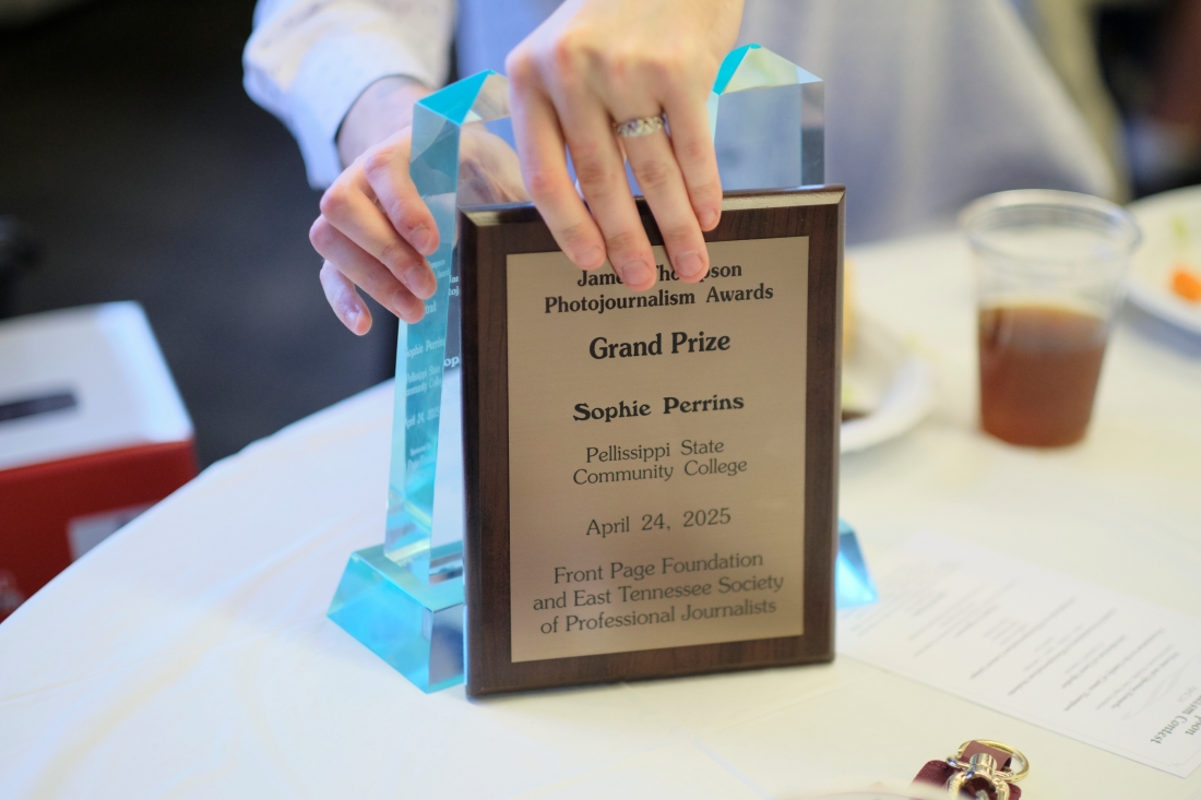 Hands repositions a plaque.