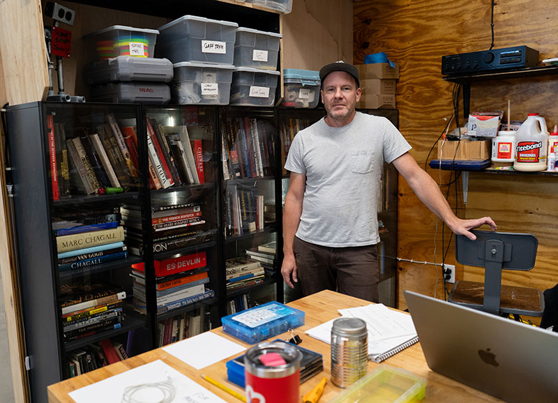 Professor Claude Hardy hanging out at his desk in the workshop