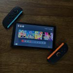 The Nintendo Switch 2 on a surface, with the Switch 2 in the middle of the two new joy-cons