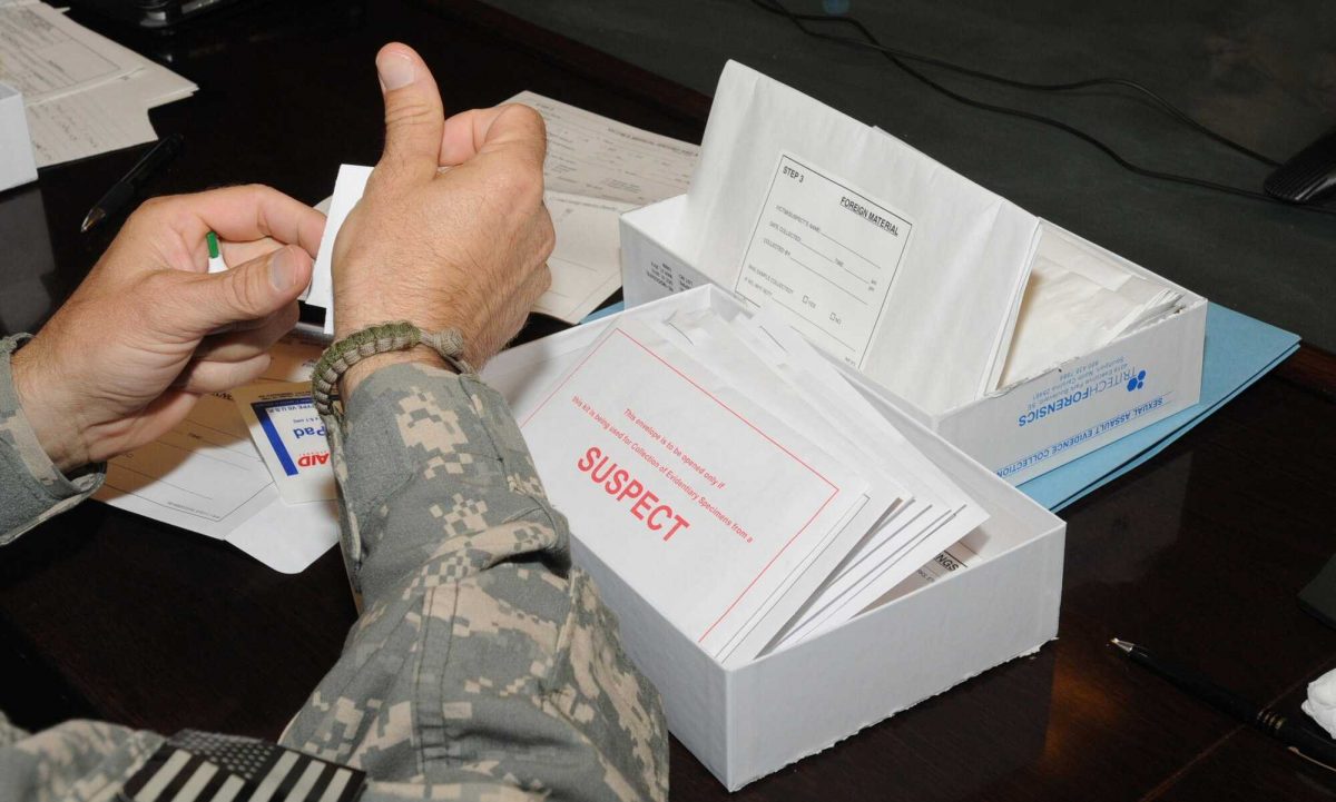 A medical professional examine a rape kit.