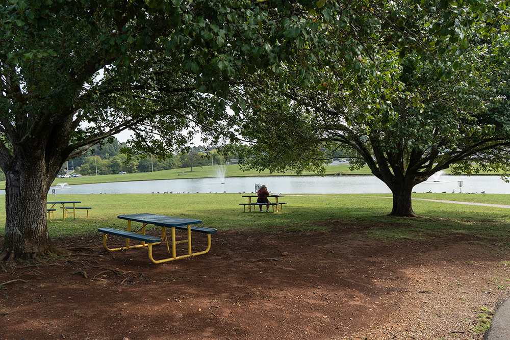Picnic tables by the duck pond across from the Goins building