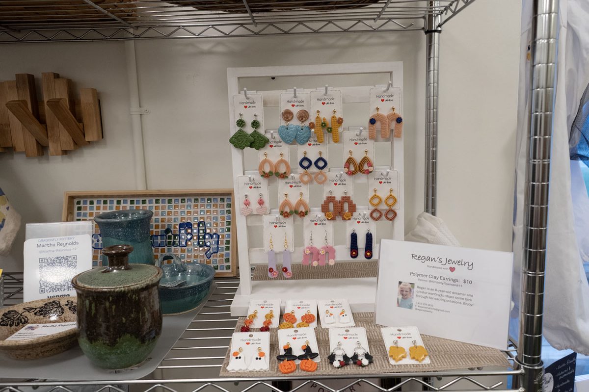 Different earrings sitting in a hanging display with colorful and seasonal options