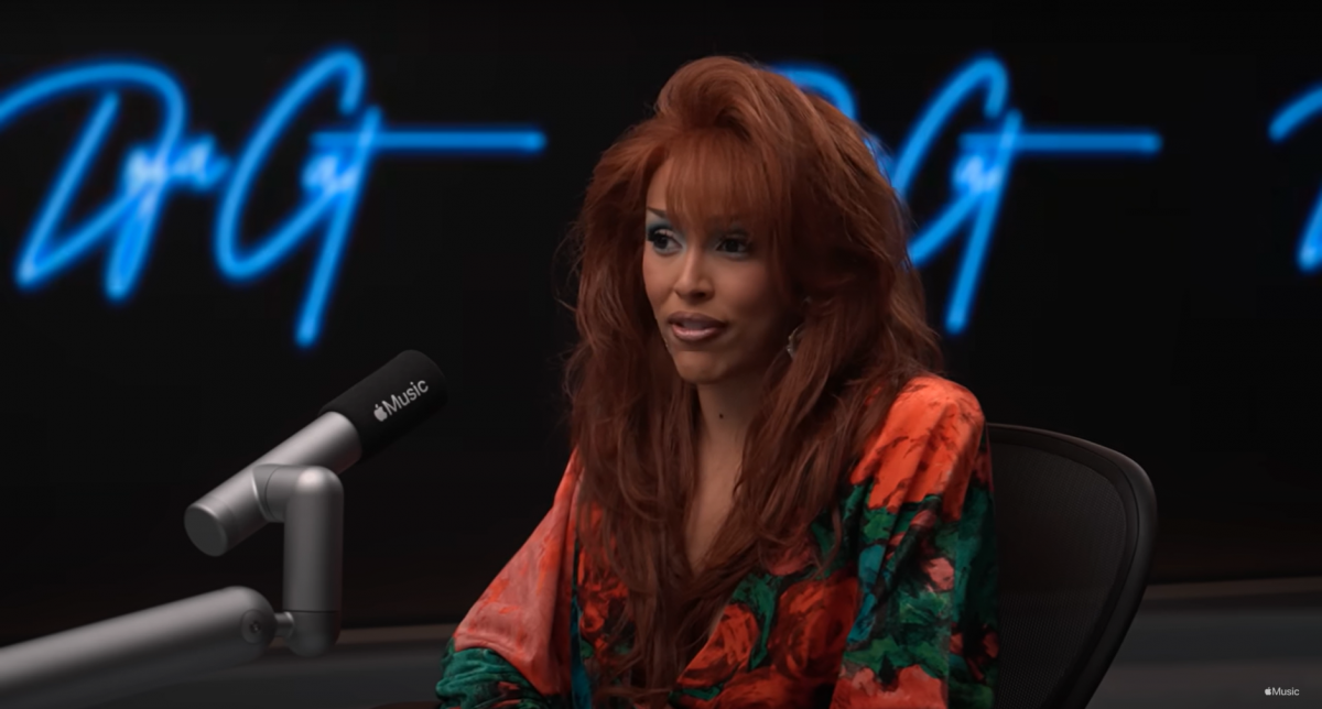 Doja Cat in an interview, wearing a vintage outfit with new fringed hair