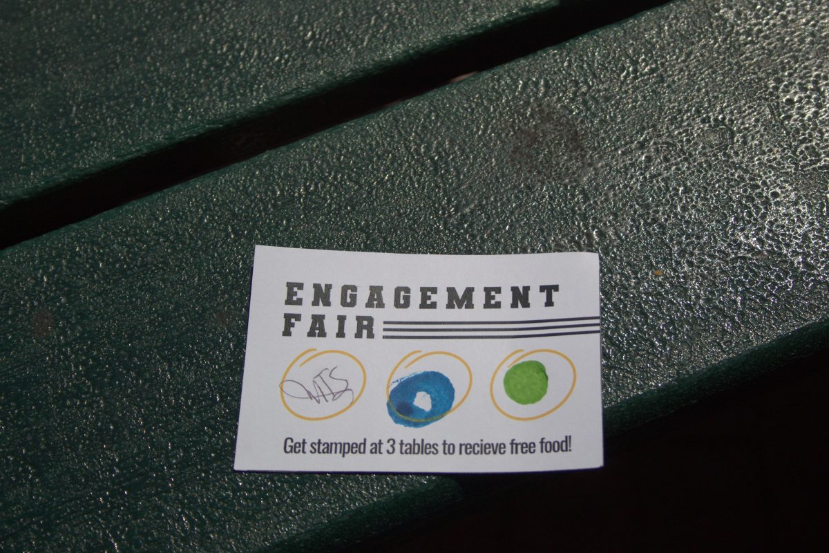 A card with three stamps on it that says “Engagement Fair. Get stamped at 3 tables to receive free food!”