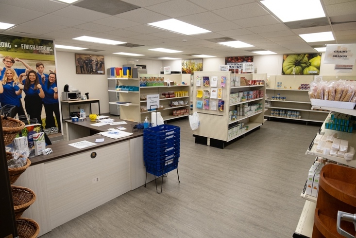 A small room filled with shelves, with a counter.
