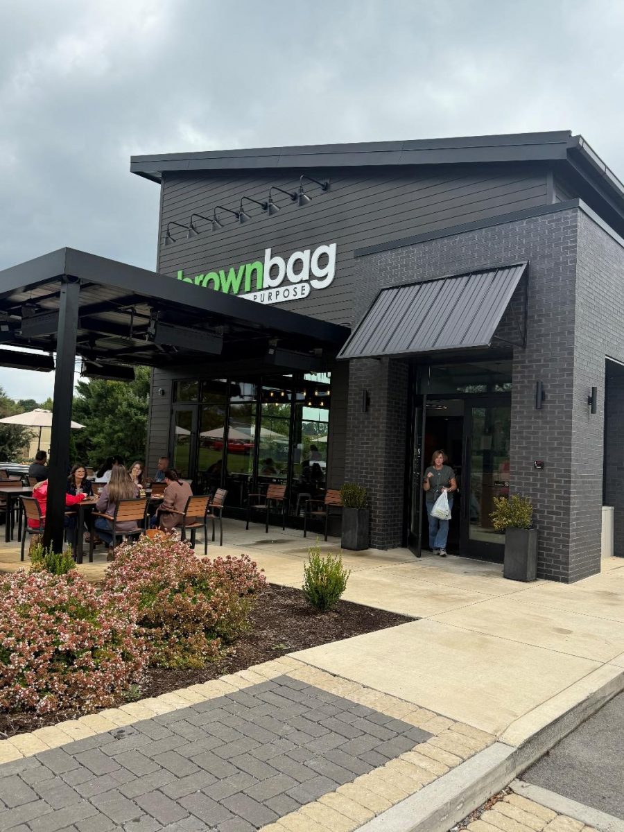 The outside of the "Brownbag" building, with customers both sitting outside and walking out of it