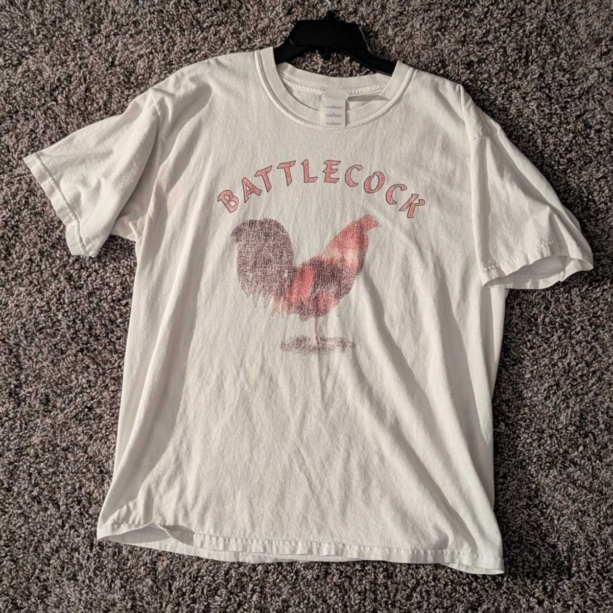 A shirt with a chicken on it with the word "Battlecock" above it