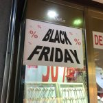 A jewelry store window with a Black Friday sign
