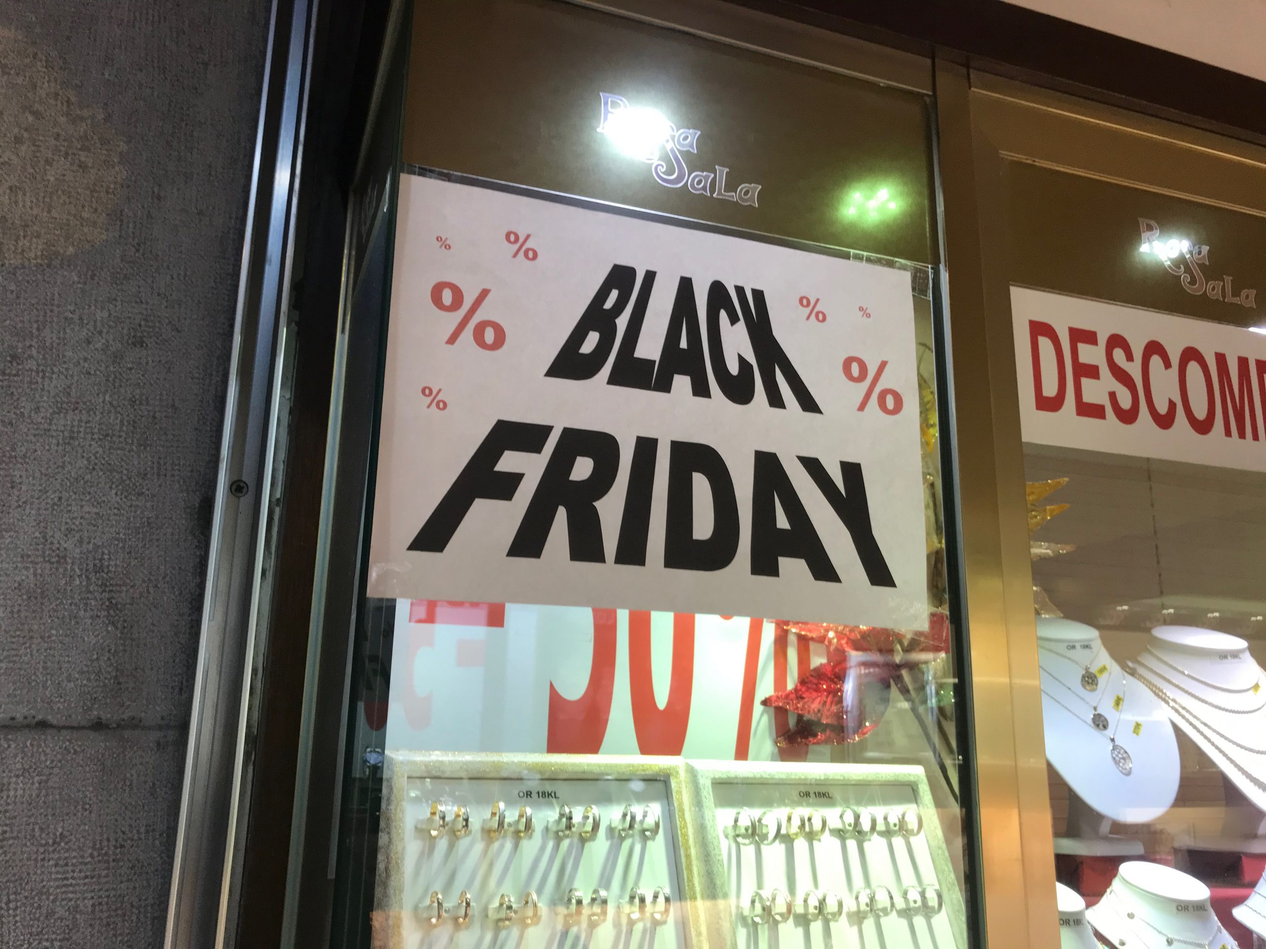 A jewelry store window with a Black Friday sign