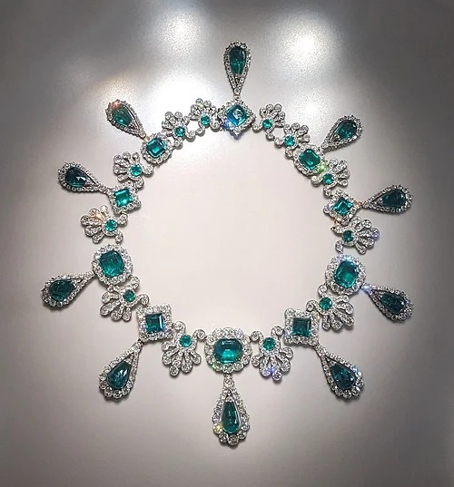 A necklace with emerald gemstones.
