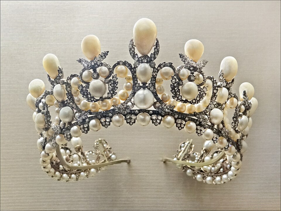 A tiara with pearls and diamonds on it.