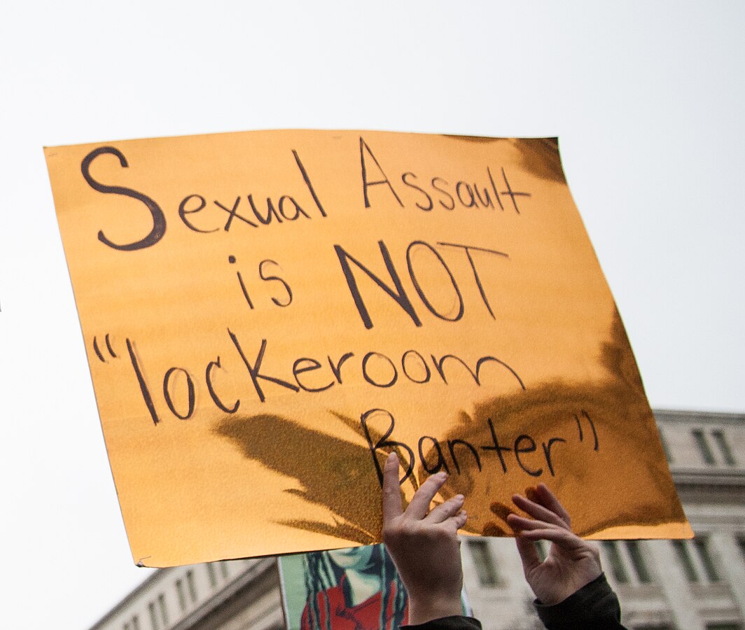 Protest sign saying “Sexual Assault is NOT ‘lockeroom Banter’”