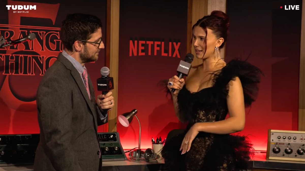 A woman and a man standing together in a retro recording studio