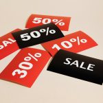 Black and red sales tags in a pile