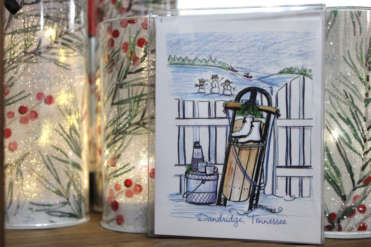 a handmade Christmas card with artwork depicting a sled, cocoa, and ice skates with "Dandridge, Tennessee" on the bottom