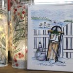 a handmade Christmas card with artwork depicting a sled, cocoa, and ice skates with "Dandridge, Tennessee" on the bottom