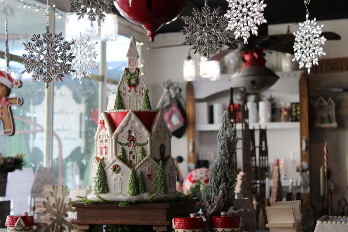 a porcelain light-up church featured in the store, surrounded by other festive decorations
