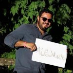 Alejandro holding a sign that says “Alejandro”