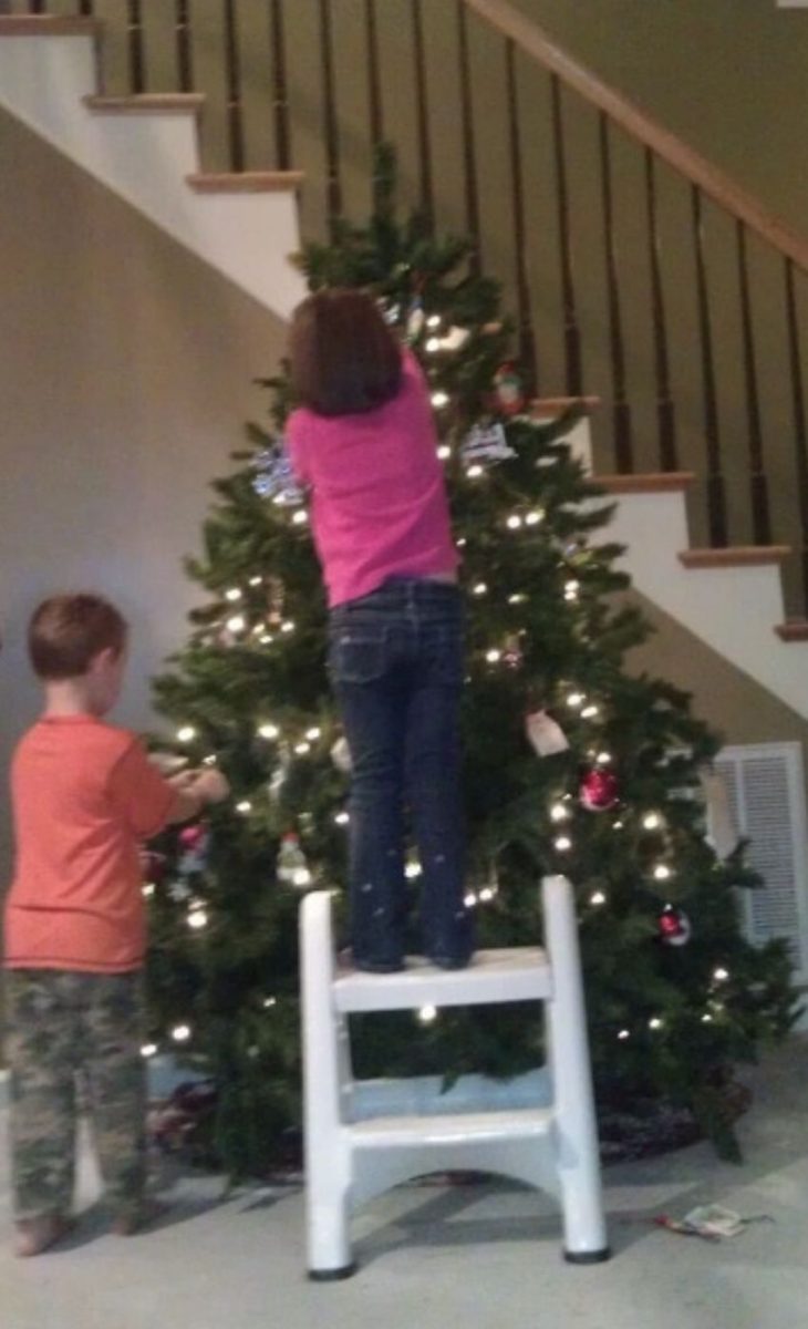 Emma and Caleb Harrison decorating their Christmas tree.