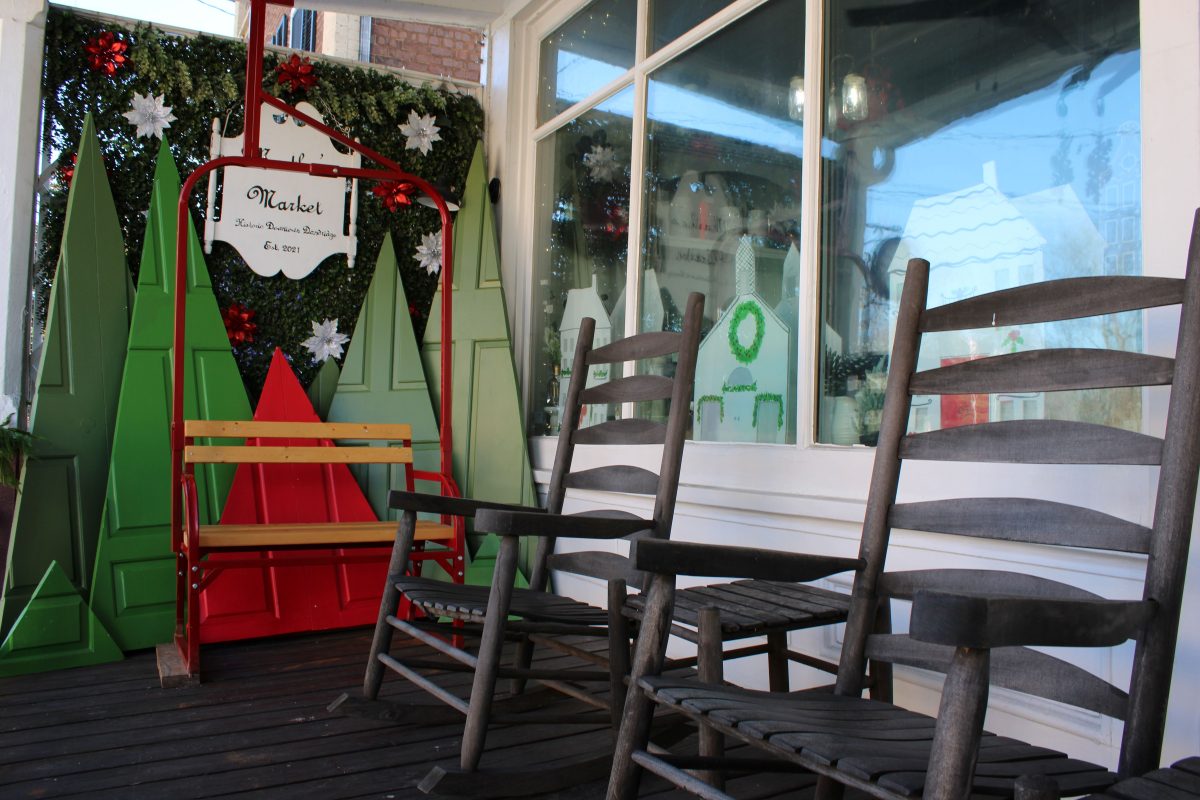 two rocking chairs with Christmas decorations with a "Martha's Market" sign