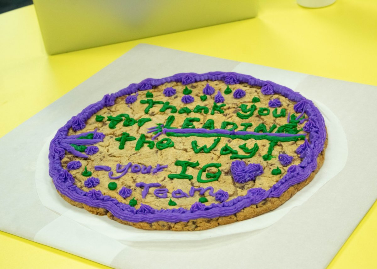 A cake that says "Thank you for LEADING the Way! IG Team" on it in frosting.