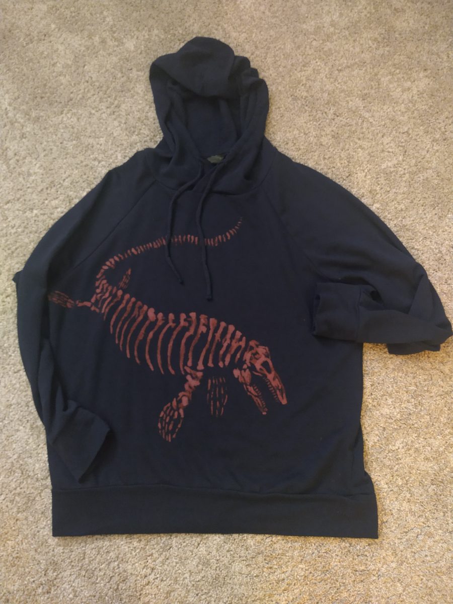 A hoodie with a bleach art of a mosasaurus fossil