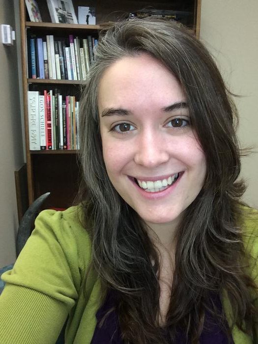 Picture of a woman with brown hair and eyes facing the camera and smiling.