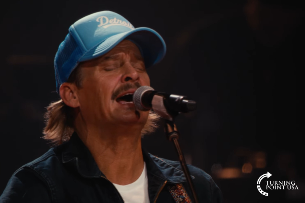 Kid Rock sings into a microphone.