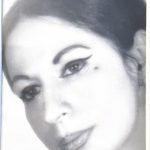 A woman with dark hair and black eyeliner with a slight smile.