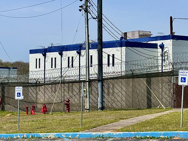 A two-story jail with a blue roof.