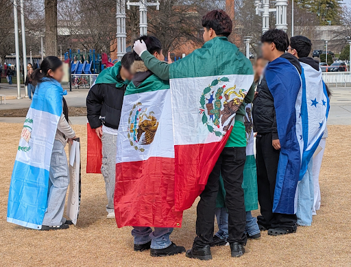 Protestors wearing the flag of Mexico as a capes