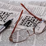 Newspaper with pen and glasses