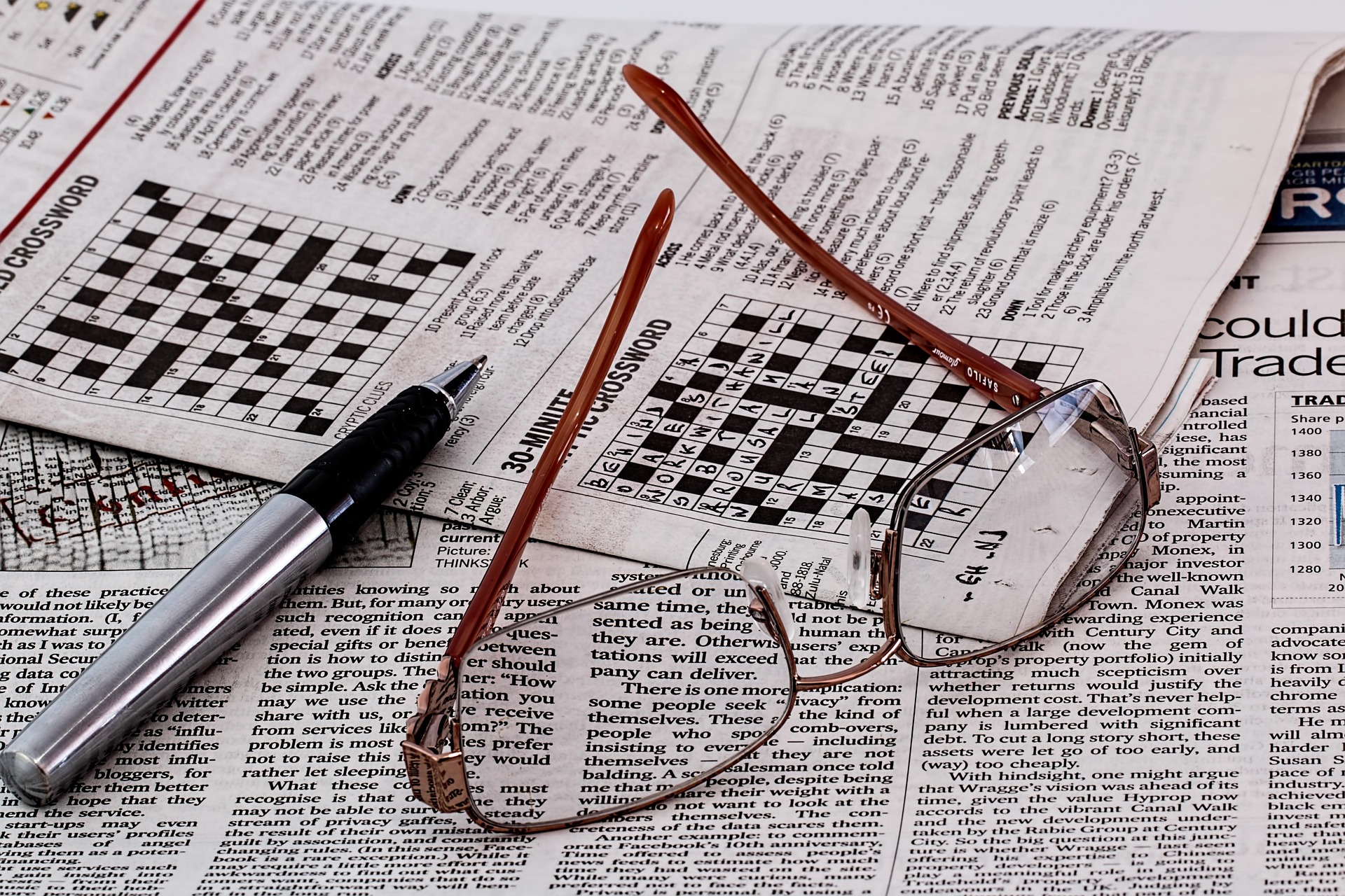 Newspaper with pen and glasses