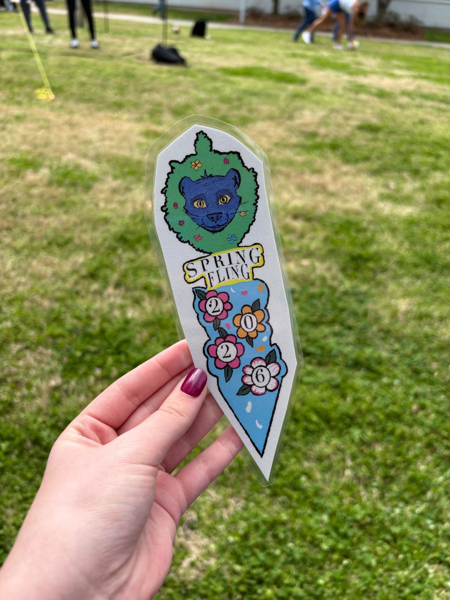 Photo of Imaginary Gardens bookmark for Spring Fling 2026 made by Evelyn Hawkey featuring Pax the Panther