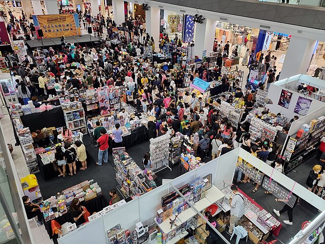 An angled down view of the dealers room in an anime convention