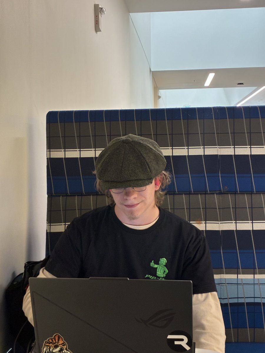 Hunter Shewmake looking at laptop