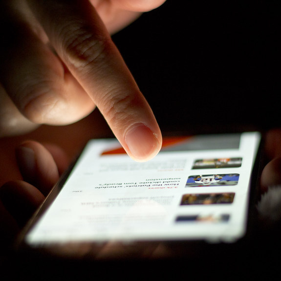 A person scrolling the news on their phone