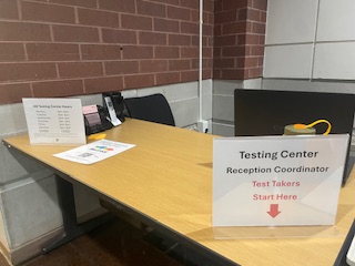 Testing center sign in table "Testing Center Reception Coordinator Test Takers Start Here"