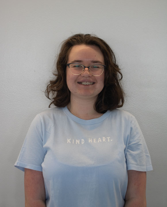 blue shirt reading "KIND HEART"