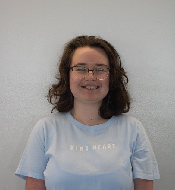 blue shirt reading "KIND HEART"